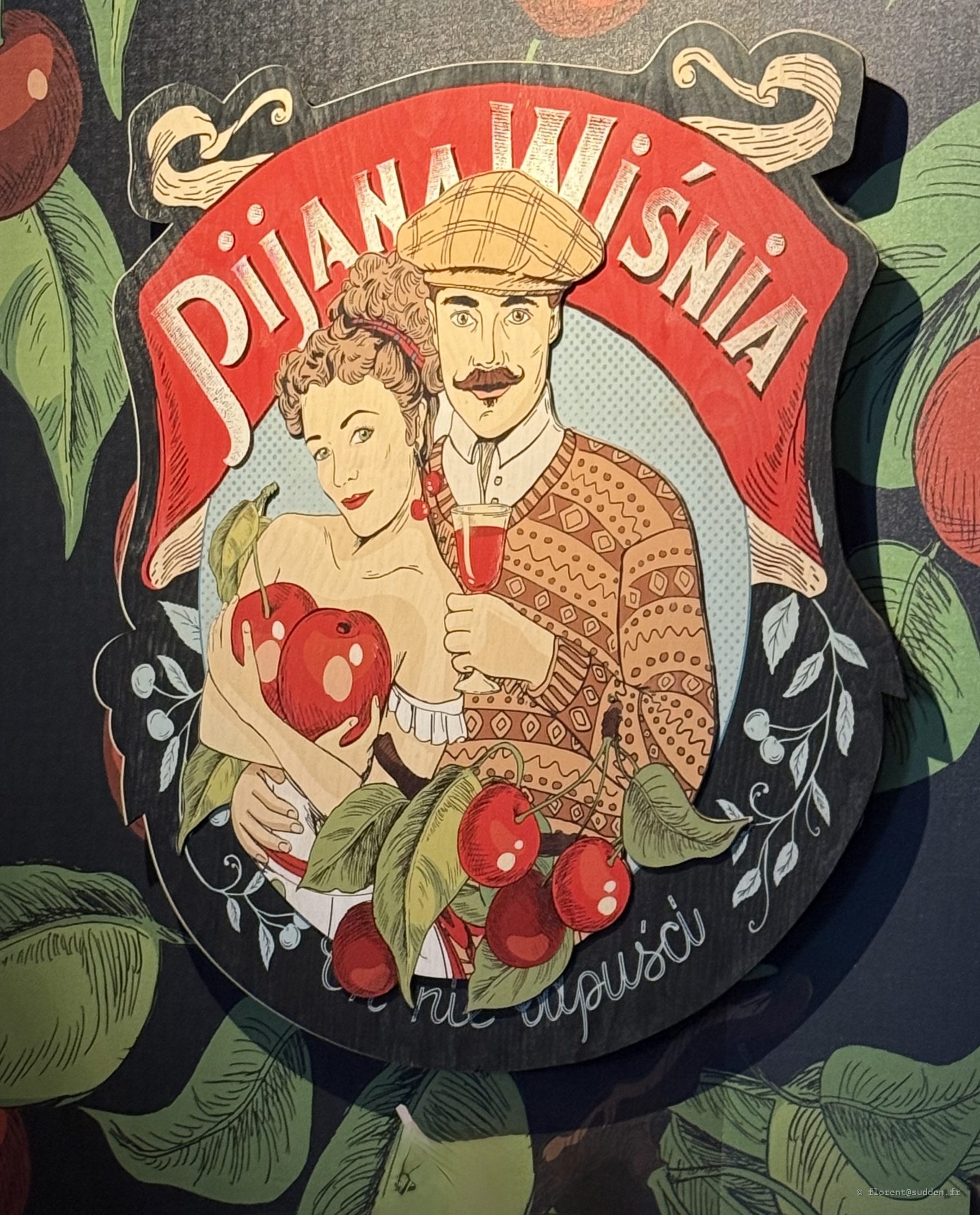 Enseigne illustrée rétro d'un bar à liqueur de cerise, Pijana Wiśnia, avec un couple et des cerises